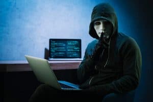 Hacker next to a computer