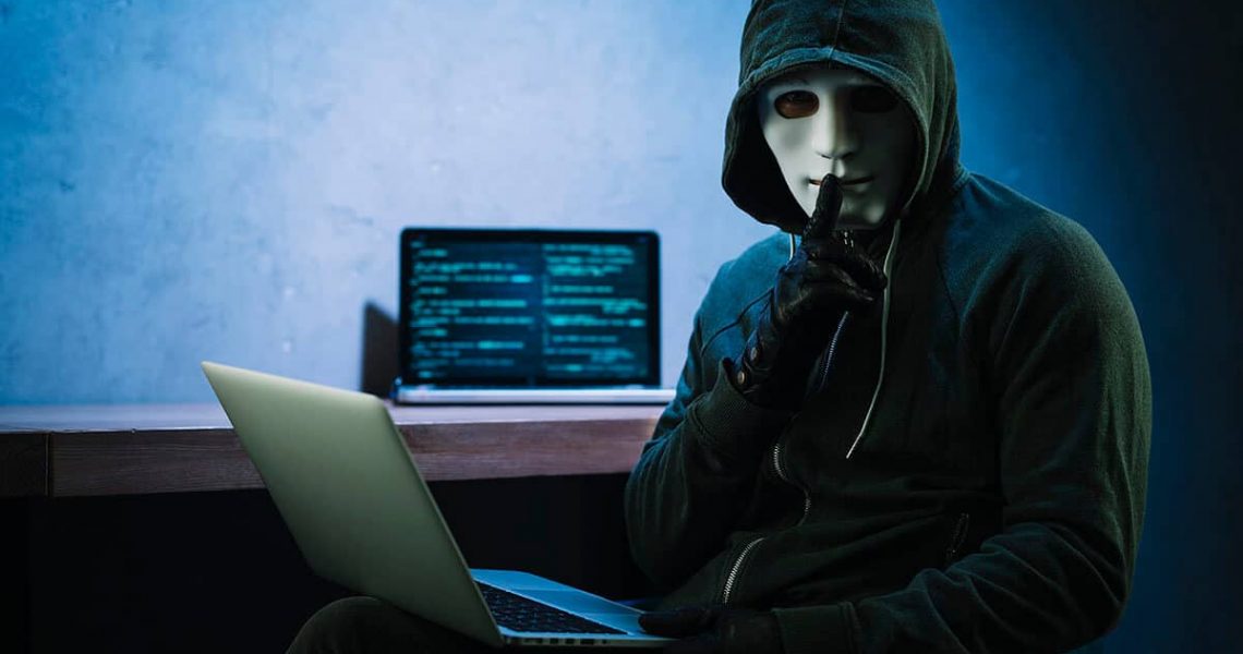 Hacker next to a computer